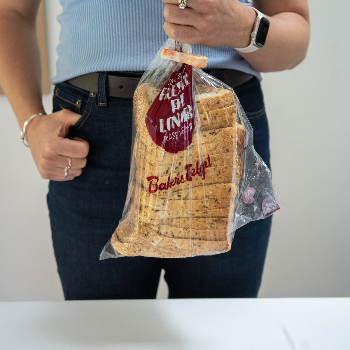 Recycled bag slide sealing a loaf of bread