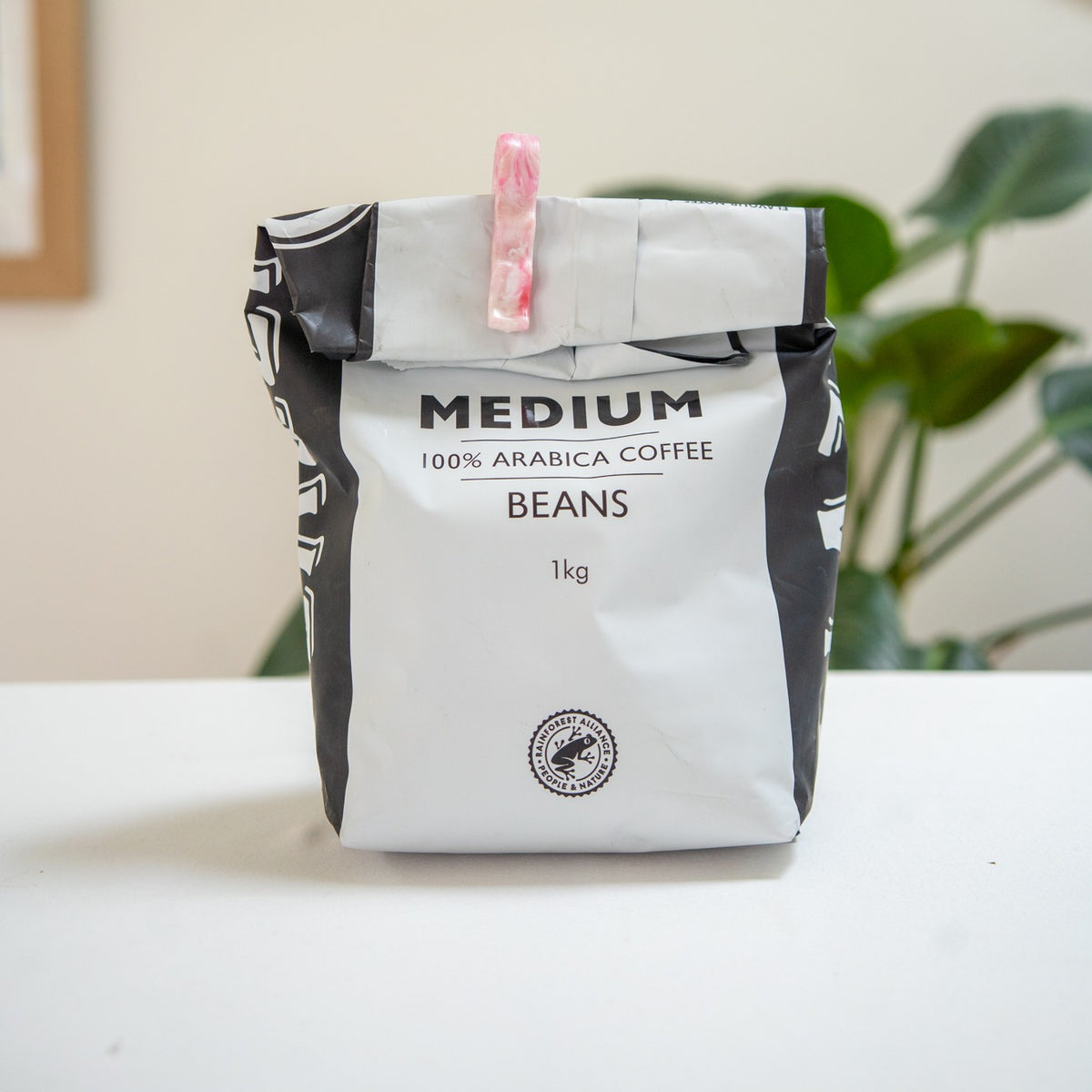 Recycled bag slide sealing a bag of coffee beans