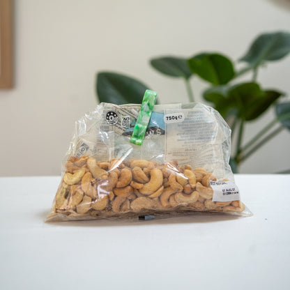 Recycled bag slide sealing a bag of cashews