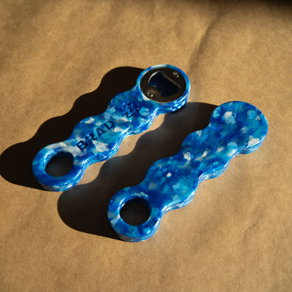 Two Deep Blue recycled bottle openers showing the marbled blue and white pattern