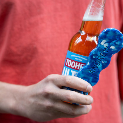 Deep Blue recycled bottle opener being used to open a bottle
