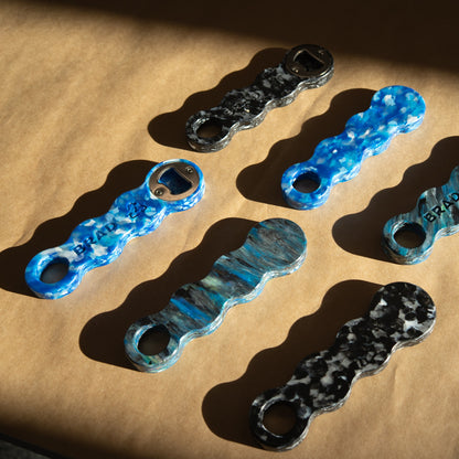 Six recycled plastic bottle openers showing that no two patterns are the same