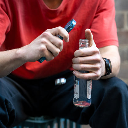 Orbital recycled bottle opener in use