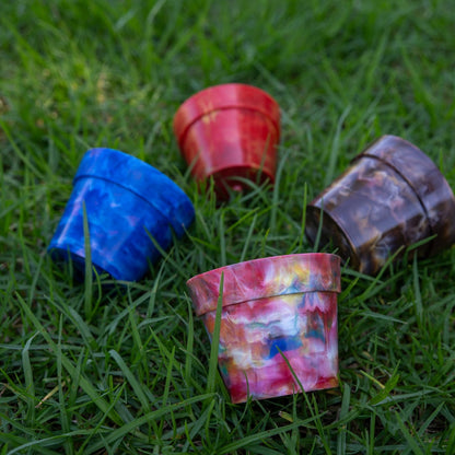 BRAD recycled plastic pot plants full colour range on grass, Blueberry, Strawberry, Chocolate and Fruit Salad planters handmade from recycled milk bottle lids collected through the BRAD recycling program